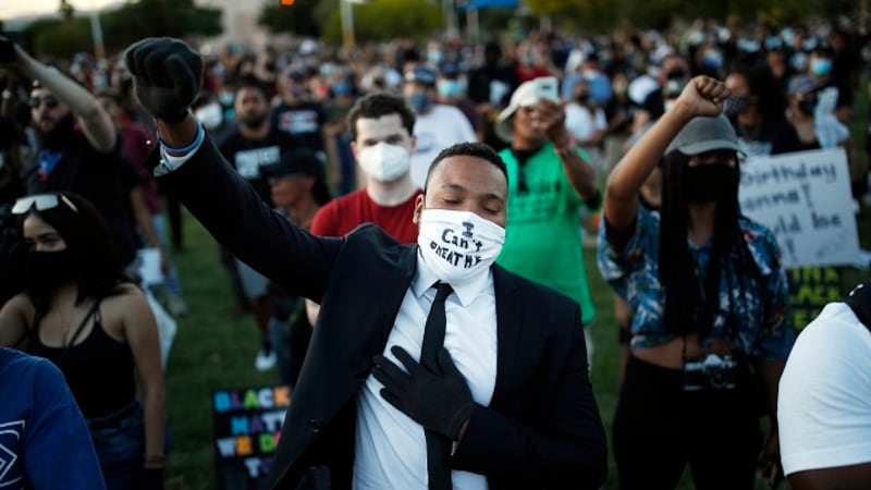 People raise their fists during a rally, Friday, June 5, 2020, in Las Vegas, against police...