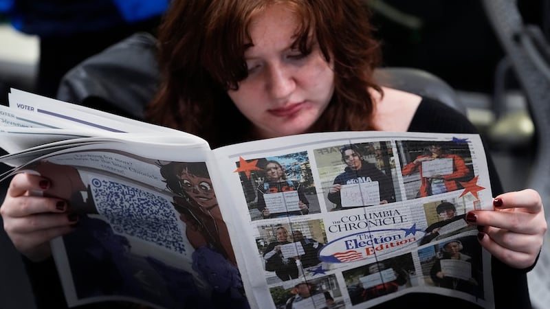 FILE - Columbia College Chicago student Kailey Ryan reads a newspaper in Chicago on Nov. 5, 2024.
