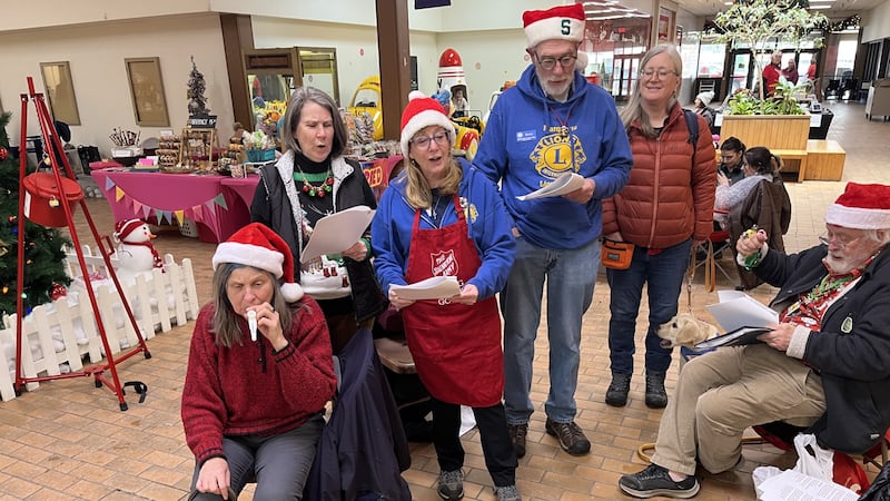 The Marquette Lions Club used their voices, bells and a kazoo to carol.