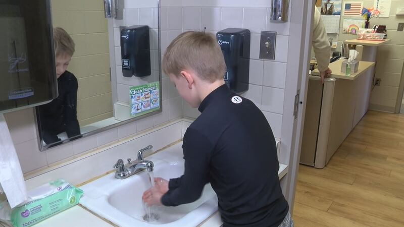 Woodland student washes hands (WLUC Photo)